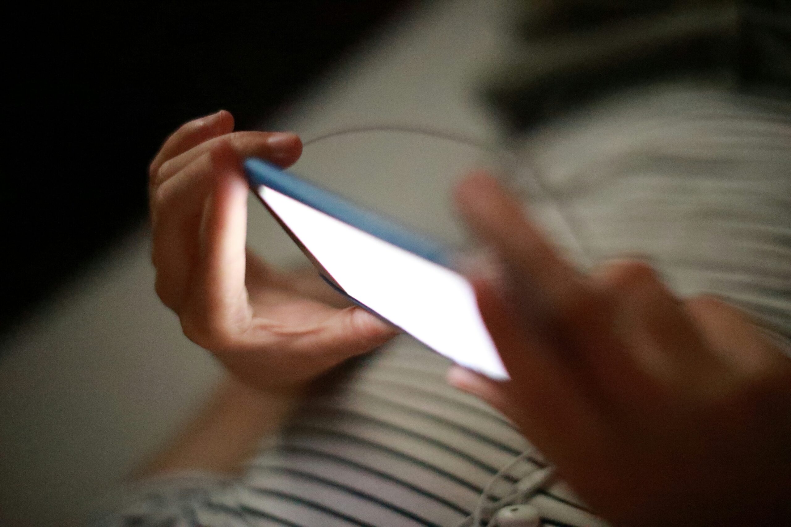 Close-up of hands using a smartphone, illustrating Generation Alpha social media habits and evolving digital behaviour.