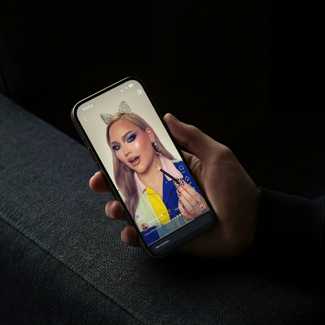Instagram makeup video on a smartphone, showing the social content creative advertising must compete with.